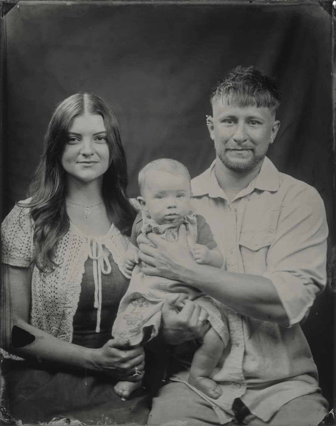 Handmade tintype portrait of a family of three.